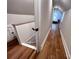 Upper hallway leads to bedroom with hardwood floors and neutral walls at 4317 Ruskin Dr, Charlotte, NC 28209
