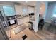 Bright kitchen with stainless steel appliances, white cabinetry, and an eat-in bar at 4317 Ruskin Dr, Charlotte, NC 28209