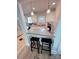 Eat-in kitchen featuring white cabinets, modern lighting, and stainless steel appliances at 4317 Ruskin Dr, Charlotte, NC 28209