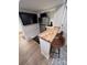 Close-up of a kitchenette with stainless steel appliances, butcher block counter, and stylish seating at 4317 Ruskin Dr, Charlotte, NC 28209
