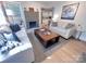 Open-concept living room with modern decor, a striking fireplace, and hardwood floors throughout at 4317 Ruskin Dr, Charlotte, NC 28209