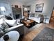Stylish living room featuring hardwood floors, modern fireplace, and designer decor at 4317 Ruskin Dr, Charlotte, NC 28209