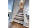 Bright staircase with painted risers and wood treads provides access to upper floors at 4317 Ruskin Dr, Charlotte, NC 28209