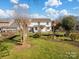 Spacious backyard with a well-maintained lawn and a two-story white house offering a serene outdoor space at 4540 Hounds Run Dr, Matthews, NC 28105