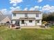 The backyard shows a patio, outdoor dining, a grill, and a large grassy area at 4540 Hounds Run Dr, Matthews, NC 28105
