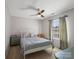 Neutral bedroom featuring a metal frame bed, ceiling fan, and bright window at 4540 Hounds Run Dr, Matthews, NC 28105