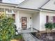 Inviting front porch area of a home with manicured bushes, potted plants, and classic decor at 4540 Hounds Run Dr, Matthews, NC 28105