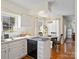 Bright kitchen with white cabinetry, dishwasher, and breakfast nook with table at 4540 Hounds Run Dr, Matthews, NC 28105