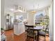 Well-lit kitchen featuring stainless steel appliances, white cabinetry, and wood floors at 4540 Hounds Run Dr, Matthews, NC 28105