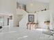Spacious living room with soaring ceilings, marble floors, and staircase at 4540 Hounds Run Dr, Matthews, NC 28105