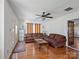 Spacious living room with hardwood floors, ceiling fan, and ample natural light at 4540 Hounds Run Dr, Matthews, NC 28105