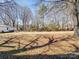 A spacious, grassy backyard with mature trees and a small building at 506 Bond St, Cherryville, NC 28021