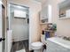 Bathroom with a white vanity, toilet, and open doorway to a laundry area at 506 Bond St, Cherryville, NC 28021