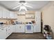 Bright kitchen featuring white cabinets, white appliances, modern countertops, and vinyl floors at 506 Bond St, Cherryville, NC 28021