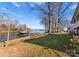 Lush backyard with waterfront views, mature trees, and a private dock, offering serene lakeside living at 5153 Glenwood St, Sherrills Ford, NC 28673