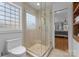 Bathroom featuring a glass enclosed shower and a toilet with storage, and a window with natural light at 5153 Glenwood St, Sherrills Ford, NC 28673