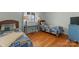 Bedroom featuring two beds, a desk between the beds, wood floors and a neutral color scheme at 5153 Glenwood St, Sherrills Ford, NC 28673