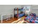 bedroom featuring a bunk bed with a colorful quilt, a twin bed, and a desk with light streaming through the window at 5153 Glenwood St, Sherrills Ford, NC 28673