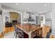Open dining room area featuring a fireplace, table and chairs, and kitchen at 5153 Glenwood St, Sherrills Ford, NC 28673