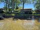 Charming home exterior with a sprawling lawn, retaining wall, and lake access at 5153 Glenwood St, Sherrills Ford, NC 28673