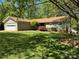 Well-maintained front exterior with a lush lawn and mature trees at 5153 Glenwood St, Sherrills Ford, NC 28673