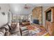 Cozy living room featuring a stone fireplace, hardwood floors, and comfortable seating at 5153 Glenwood St, Sherrills Ford, NC 28673