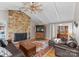 Inviting living room with stone fireplace, ceiling fan, and a beautiful hardwood front door at 5153 Glenwood St, Sherrills Ford, NC 28673