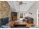 Attractive living room featuring a stone fireplace, hardwood floors, and ceiling fan at 5153 Glenwood St, Sherrills Ford, NC 28673