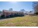 Expansive backyard featuring a detached garage, patio, and a well-manicured lawn at 605 Castlewood Dr, Gastonia, NC 28056