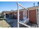 Inviting backyard featuring a porch swing, a red brick exterior, and a cozy patio at 605 Castlewood Dr, Gastonia, NC 28056