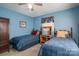 Comfortable bedroom with twin beds, wooden desk, and a ceiling fan at 605 Castlewood Dr, Gastonia, NC 28056