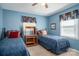 Blue bedroom features twin beds, matching curtains, and a wooden desk at 605 Castlewood Dr, Gastonia, NC 28056
