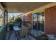 This covered patio has brick siding and a glass sliding door, perfect for outdoor dining at 605 Castlewood Dr, Gastonia, NC 28056