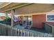 Covered patio featuring neutral furniture and an exterior brick siding at 605 Castlewood Dr, Gastonia, NC 28056