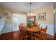 Traditional dining room with wood table, chairs, hutch, and view to the outside through sliding door at 605 Castlewood Dr, Gastonia, NC 28056