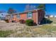 Charming brick home featuring a well-maintained lawn and complementary blue shutters at 605 Castlewood Dr, Gastonia, NC 28056