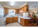 Functional kitchen with wood cabinetry, white countertops, tile flooring, and an opening to the dining room at 605 Castlewood Dr, Gastonia, NC 28056