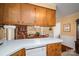 This spacious kitchen features wood cabinetry, white countertops, and stainless steel appliances at 605 Castlewood Dr, Gastonia, NC 28056
