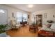 Cozy living room with traditional furnishings, wood laminate flooring, and natural light at 605 Castlewood Dr, Gastonia, NC 28056
