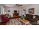 Inviting living room with wood floors, a ceiling fan, and a comfortable brown sofa at 605 Castlewood Dr, Gastonia, NC 28056