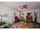 A well-lit living room featuring hardwood floors, a ceiling fan, and comfortable seating at 605 Castlewood Dr, Gastonia, NC 28056