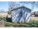 Storage shed in backyard features window air conditioner and chain link fence at 605 Castlewood Dr, Gastonia, NC 28056