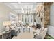 Comfortable living room featuring a stone fireplace, coffered ceiling, and ample natural light from large windows at 8002 Pemswood St, Charlotte, NC 28277