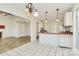 Kitchen featuring tiled floor, modern pendant lights and opening to living room at 8419 Belstead Brook Ct, Charlotte, NC 28216