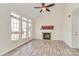 Bright living room features vaulted ceilings, many windows, and a cozy fireplace at 8419 Belstead Brook Ct, Charlotte, NC 28216