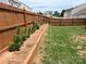 Landscaped backyard featuring a wooden fence and a raised garden bed, great for gardening at 908 Morien St, Richburg, SC 29729