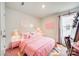 Stylized bedroom with pink accents, plush bedding, and unique decor at 908 Morien St, Richburg, SC 29729