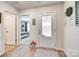 Bright entryway featuring wood-look flooring, a white door with frosted glass, and views into the bedroom at 908 Morien St, Richburg, SC 29729