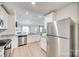 Open kitchen with stainless steel appliances, granite countertops, white cabinets, and a view into the living area at 908 Morien St, Richburg, SC 29729