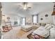 Open-concept living area with a large sectional sofa, white dining table, breakfast bar, and access to the kitchen at 908 Morien St, Richburg, SC 29729